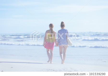 stylish mother and teenage daughter at beach walking stylish mother and teenage daughter at beach walking 101539290