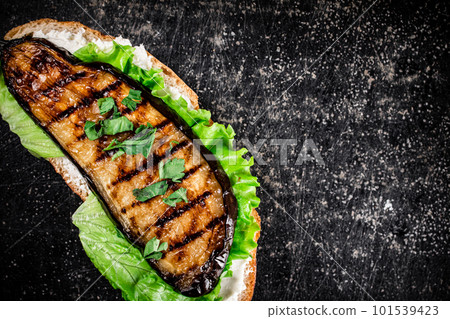 One sandwich with eggplant grilled on the table. 101539423