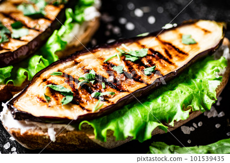 Grilled eggplant sandwich on a stone board. Grilled eggplant sandwich on a stone board. 101539435