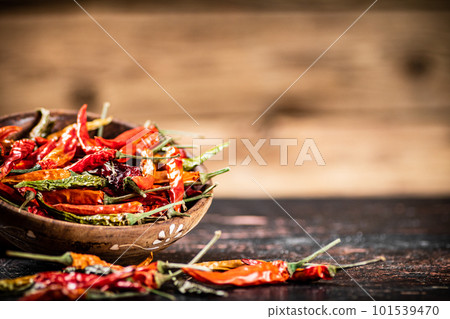 Dried chili peppers in a plate on the table. Dried chili peppers in a plate on the table. 101539470