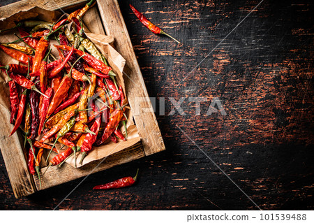 Dried chili peppers in a wooden tray. Dried chili peppers in a wooden tray. 101539488