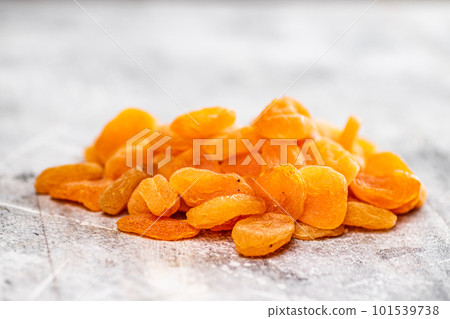 A pile of delicious dried apricots on the table. A pile of delicious dried apricots on the table. 101539738