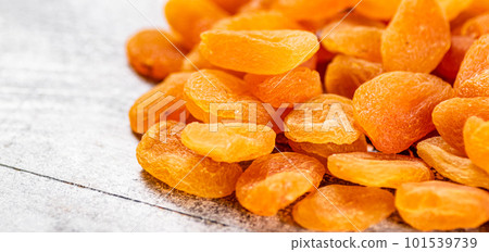 A pile of delicious dried apricots on the table. 101539739
