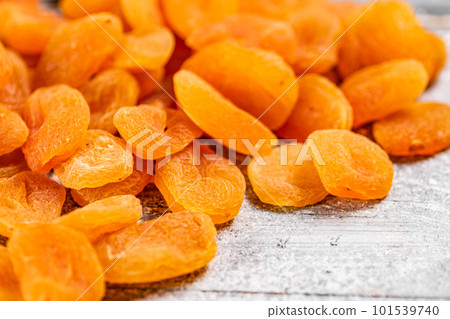 A pile of delicious dried apricots on the table. 101539740