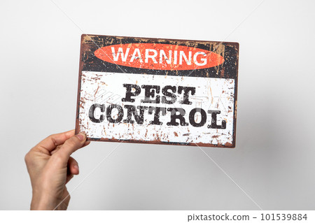 Pest Control. Warning sign with text in woman hand. white background Pest Control. Warning sign with text in woman hand. white background 101539884