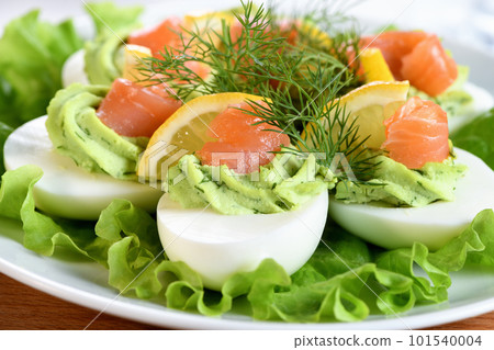 Stuffed eggs with avocado and salmon Stuffed eggs with avocado and salmon 101540004