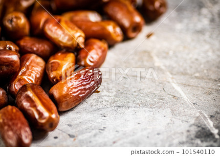A pile of ripe dates on the table. A pile of ripe dates on the table. 101540110