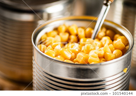 An open can of canned corn. An open can of canned corn. 101540144