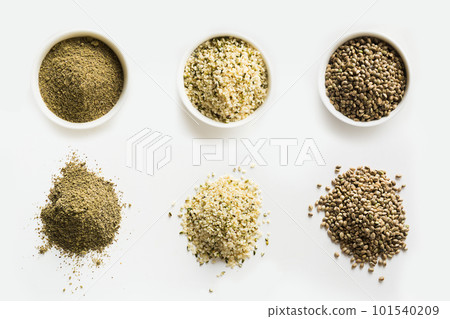 Hemp as seeds, flour, kernels in piles and bowls. 101540209