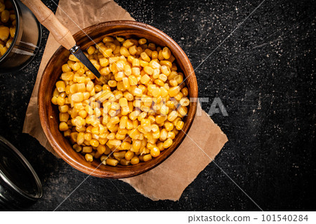 Canned corn on a wooden plate. Canned corn on a wooden plate. 101540284