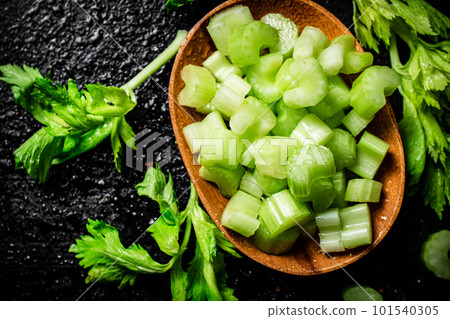Pieces of celery in a wooden plate on the table. 101540305