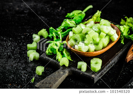 Fresh celery slices on a cutting board. 101540320