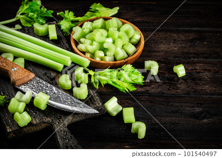 Sliced fresh celery. On a dark wooden background. 101540497