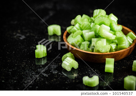 Pieces of fresh celery in a wooden plate. 101540537