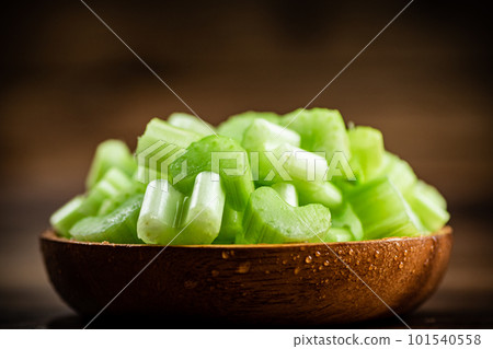 A wooden plate with a piece of celery. A wooden plate with a piece of celery. 101540558