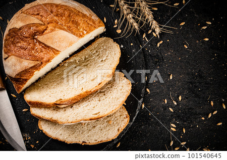 Sliced on a stone board wheat bread with grains. 101540645