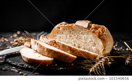 Sliced on a stone board wheat bread with grains. Sliced on a stone board wheat bread with grains. 101540656