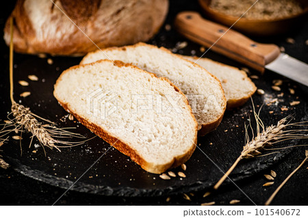 Sliced on a stone board wheat bread with grains. Sliced on a stone board wheat bread with grains. 101540672