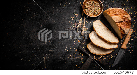 Slices of fresh bread on a cutting board. 101540678