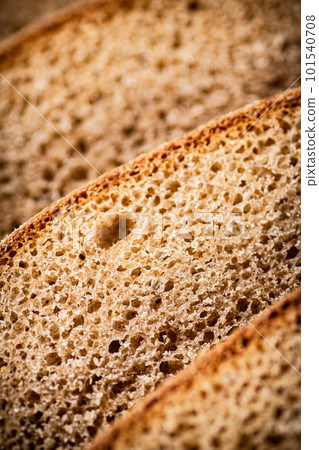 Slices of rye bread. Macro background. 101540708