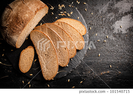 Slices of fresh bread on a stone board. Slices of fresh bread on a stone board. 101540715