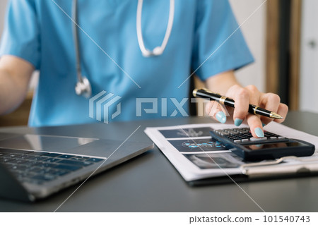 Doctors use a service fee calculator to save money on health insurance, drug cost concepts. 101540743