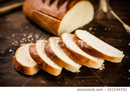 Sliced wheat bread. On a wooden background. 101540782