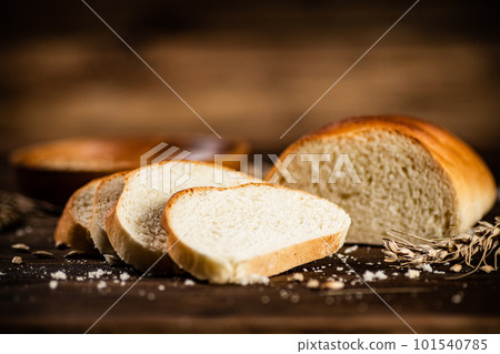 Sliced wheat bread. On a wooden background. Sliced wheat bread. On a wooden background. 101540785
