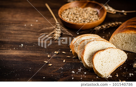 Sliced wheat bread. On a wooden background. Sliced wheat bread. On a wooden background. 101540786