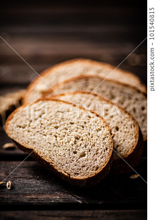 Slices of sliced bread on a table with a spike. Slices of sliced bread on a table with a spike. 101540815
