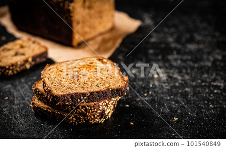 Sliced rye bread on paper. 101540849