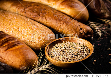 Various bread with grain in a bowl on the table. 101541134