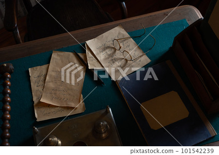 Vintage letters, glasses, pen and inkwell on a wooden table 101542239