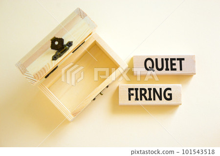 Quiet firing symbol. Concept words Quiet firing on wooden blocks. Beautiful white table white background. Empthy wooden chest. Business and quiet firing concept. Copy space. 101543518