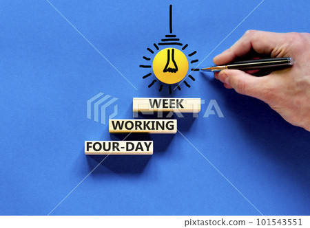 Four-day working week symbol. Concept words Four-day working week on wooden block on a beautiful blue table blue background. Businessman hand. Business four-day working week concept. Copy space. Four-day working week symbol. Concept words Four-day working week on wooden block on a beautiful blue table blue background. Businessman hand. Business four-day working week concept. Copy space. 101543551