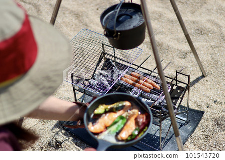 A girls' camp with a toy poodle Leisurely island camp on the blue sea and beautiful beach A woman enjoying camp food 101543720