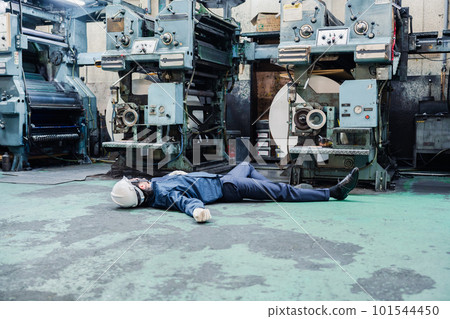 A staff member dealing with a work accident at a factory A staff member dealing with a work accident at a factory 101544450