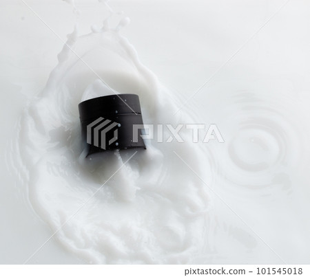 Cosmetic container white lotion droplet fly splashing. Milk lotion pour float to cosmetic bottle. Moisturizer lotion explosion spill. White background isolated high speed shutter freeze top view Cosmetic container white lotion droplet fly splashing. Milk lotion pour float to cosmetic bottle. Moisturizer lotion explosion spill. White background isolated high speed shutter freeze top view 101545018