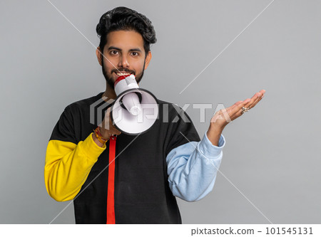 Man talking with megaphone, proclaiming news, loudly announcing advertisement pointing empty place 101545131