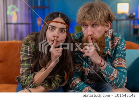 Family man woman presses finger to lips makes silence hush sign do not tells gossip secret, quiet Family man woman presses finger to lips makes silence hush sign do not tells gossip secret, quiet 101545142