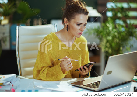 pensive business owner woman in sweater in green office pensive business owner woman in sweater in green office 101545324