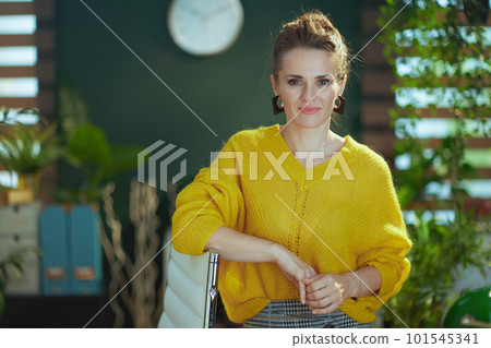 business owner woman in sweater standing in green office business owner woman in sweater standing in green office 101545341