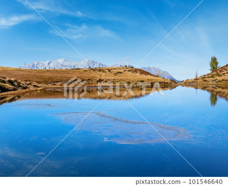 Autumn alpine Kleiner Paarsee or Paarseen lake, Land Salzburg, Austria. Alps Hochkonig rocky mountain group view in far. Autumn alpine Kleiner Paarsee or Paarseen lake, Land Salzburg, Austria. Alps Hochkonig rocky mountain group view in far. 101546640