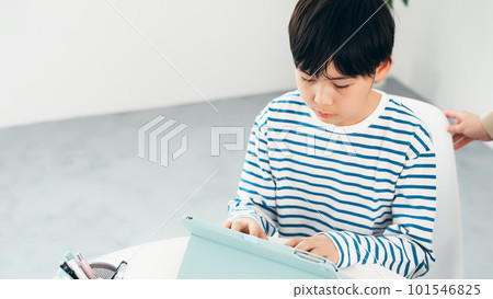 Boy touching the tablet screen Boy touching the tablet screen 101546825