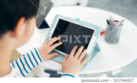 Boy touching the tablet screen 101546827