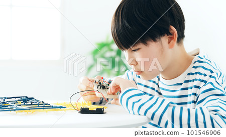 boy doing electronic work boy doing electronic work 101546906
