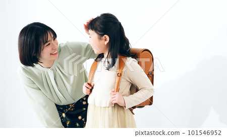 Girl and mom carrying a school bag Girl and mom carrying a school bag 101546952