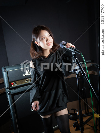 Young woman photographing in recording studio Young woman photographing in recording studio 101547700