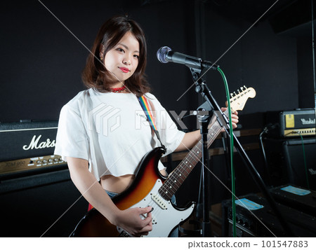 Woman playing guitar Woman playing guitar 101547883