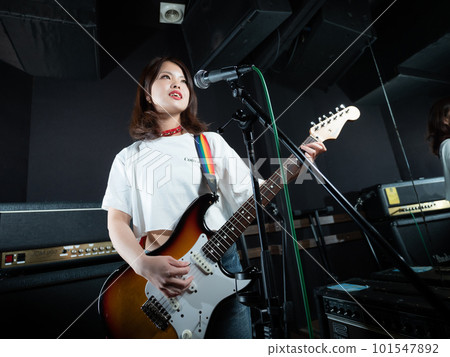 Woman playing guitar Woman playing guitar 101547892